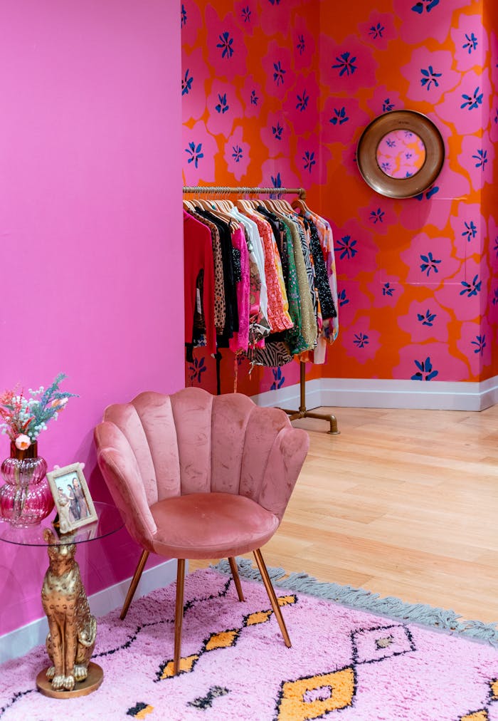 Mastering the First Impression: Your intriguing post title goes here Colorful room with pink armchair and clothing rack creating a chic boutique vibe.