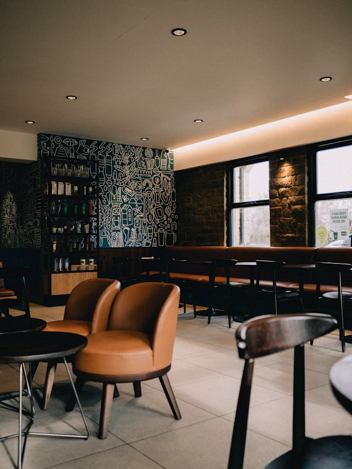 Crafting Captivating Headlines: Your awesome post title goes here Inviting modern coffee shop interior with leather seating, designed for relaxation and socializing.