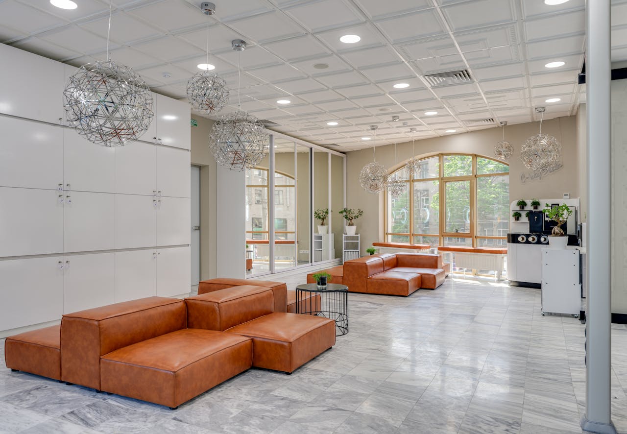 our-story Spacious modern lounge featuring leather sofas and contemporary lighting, ideal for luxury interior design concepts.